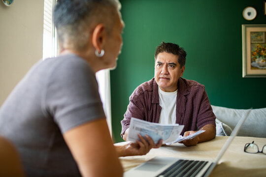 Two adults reviewing household bills at home