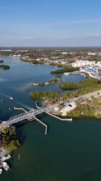 Still shot of boats passing under a historic swing bridge near Blackburn Point and Casey Key in Sarasota, Florida. 