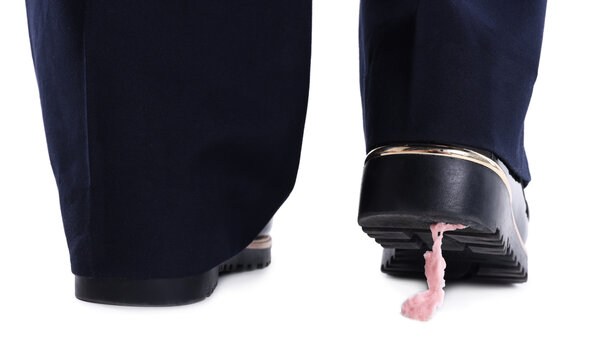 Chewing gum stuck to sole of woman's shoe on white background, closeup. Stickiness concept