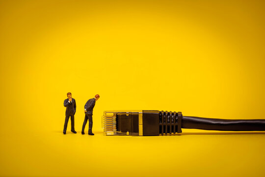 Miniature Business people with internet network cable. Technology concept