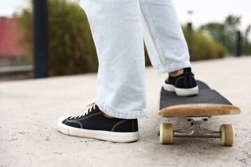 Man riding skateboard on city street, closeup © New Africa