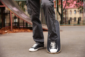 Man riding skateboard in skate park, closeup © New Africa