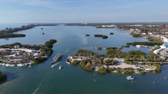 Boats passing through a historic swing bridge at Blackburn Point near Casey Key in Sarasota, Florida. 