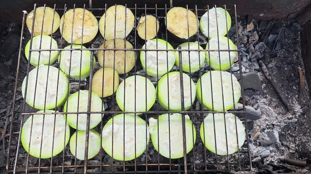 Grilling vegetables on a barbecue at a campsite during the afternoon