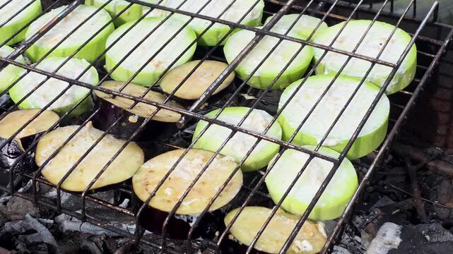 Grilling vegetables over an open flame at a market in summer