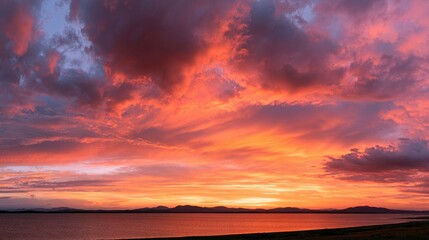 Fototapeta premium Wide-angle sunset panorama: dramatic clouds and vibrant hues