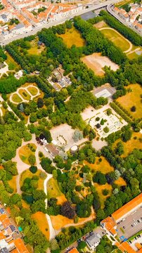 Vertical video. Nancy, France. Pepinier Park - Forest park with walking paths, rose garden, playgrounds and sports grounds. Summer, Sunny day. Drone footage. Rich colors
