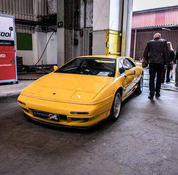 Gothenburg, Sweden - May 30 2026: Yellow Lotus Esprit S4 displayed near industrial doorway.