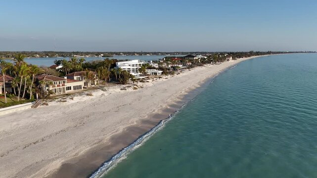 Luxury oceanfront homes along an empty sandy beach at Casey Key, a barrier island, in Sarasota County, Florida. 