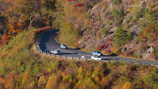 Roadside observation point in Tennessee mountains with parked car overlooking vibrant fall forest and peaceful natural scenery.
