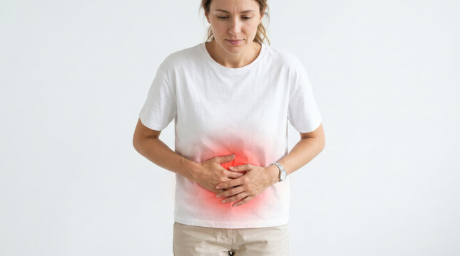 Stressed person touching abdomen with glowing red focal point symbolizing severe digestive issues against plain white background.