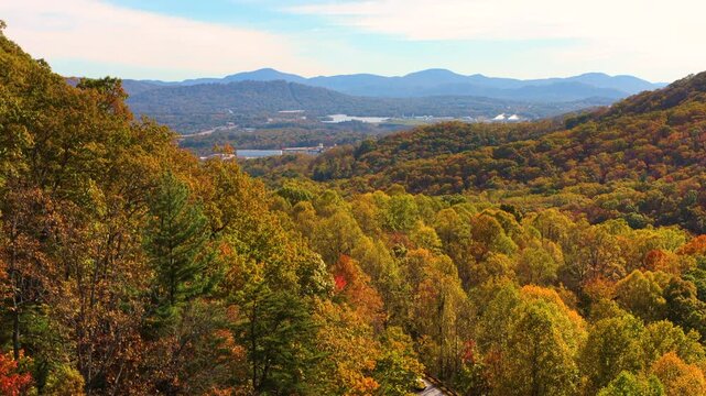 Spectacular autumn scenery featuring colorful forest across rolling mountain terrain. Vibrant foliage creates peaceful and picturesque landscape.
