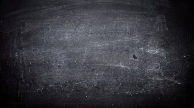 A dark, textured chalkboard surface with visible scratches, smudges, and faint dust. Perfect for creative backgrounds.