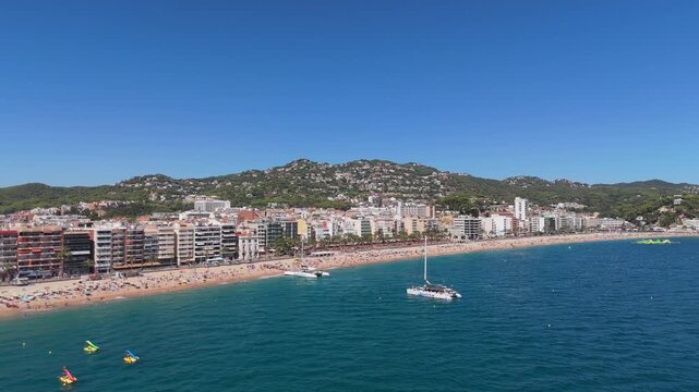 Aerial view taken from a drone of the coast of Lloret de Mar, Costa Brava, Spain, at sunny day - the sea, beach and coastal hotels