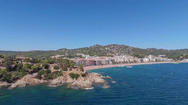 Aerial view taken from a drone of the coast of Lloret de Mar, Costa Brava, Spain, at sunny day - the sea, beach and coastal hotels
