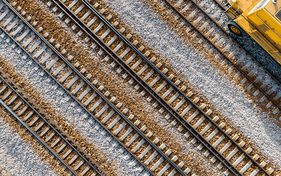 High angle view of parallel railway tracks with gravel and concrete sleepers
