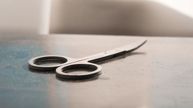 Manicure Scissors and Nail Care Tools Lying on Professional Salon Table
