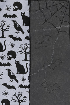 Halloween background with skull, cats, and spiders border on black marble for celebration events