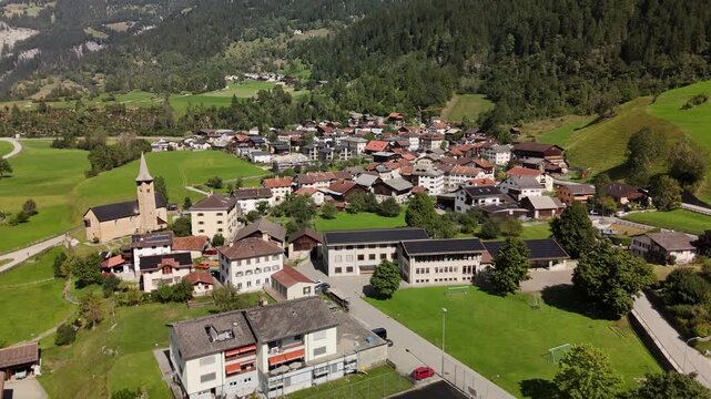Aerial drone view of Zillis-Reischen village in the green Alpine valley of Graubunden, Switzerland