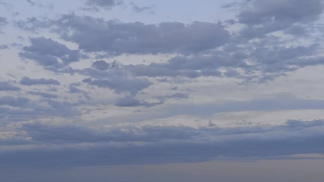 Grey stratocumulus clouds moving in the sky