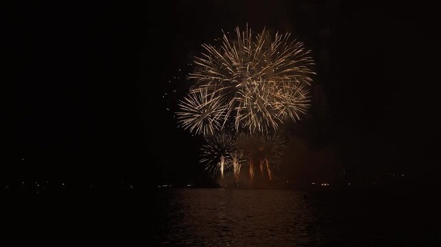 Golden fireworks over sa Palomera rock at night, Blanes, Spain