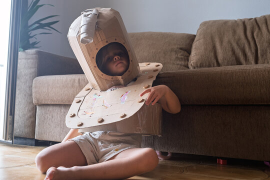  Girl Wearing a Homemade Cardboard Costume Looking Surprised Indoors