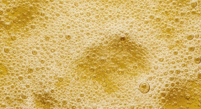 Beer foam bubbles close up texture background featuring golden carbonated liquid with macro circular air spheres in bright lighting