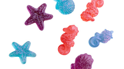 Isolated vibrant glitter candies shaped as sea creatures including starfish seahorses and seashells. © Cian