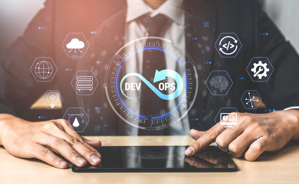 Professional using digital tablet with DevOps icons and symbols, demonstrating modern software development and IT operations integration in a business environment Quark.