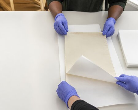Museum Collection Disaster Recovery - archive salvage team interleaves damp paper with blotters