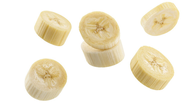 Isolated fresh ripe banana slices perfectly cut and scattered, nutritious tropical fruit snack.