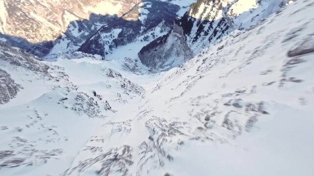 Breathtaking FPV Drone Dive Down a Massive Snowy Mountain Cliff Towards ValleyBreathtaking FPV Drone Dive Down a Massive Snowy Mountain Cliff Towards Valley