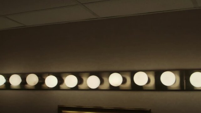 Row of Round Vanity Mirror Lights Against Ceiling