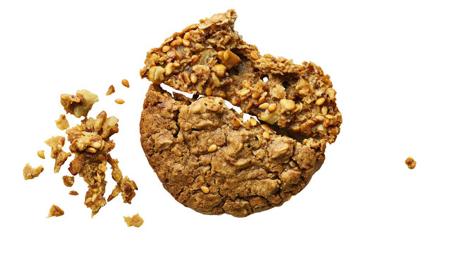 Isolated broken oatmeal granola cookie with scattered crumbs and seeds, a healthy and crunchy snack.