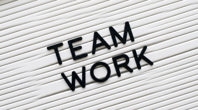 Team Work text on a white letter board for business collaboration and corporate success