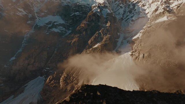 Cinematic Shot of a Dust Cloud Blowing Off a Rocky Mountain Slope