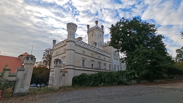 Filipov Castle historic facade framed by mature park trees