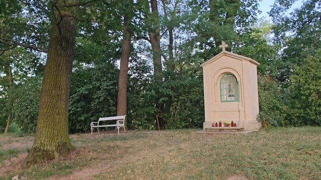 Wayside shrine decorated with candles in a quiet woodland setting
