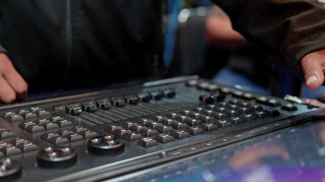 Hands operating video switcher console for live event production
