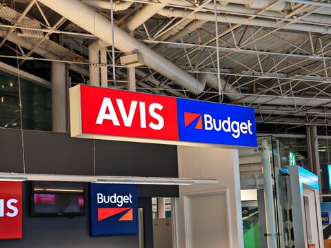 Newcastle upon Tyne,United Kingdom-12 February 2025:AVIS AND BUDGET car rental desks at Newcastle International Airport, sign closeup