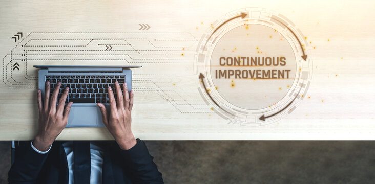 Business Professional Using Laptop Focused on Continuous Improvement with Futuristic Design Elements and Graphical Arrows Illustrating Progress Optimization Sigmoid