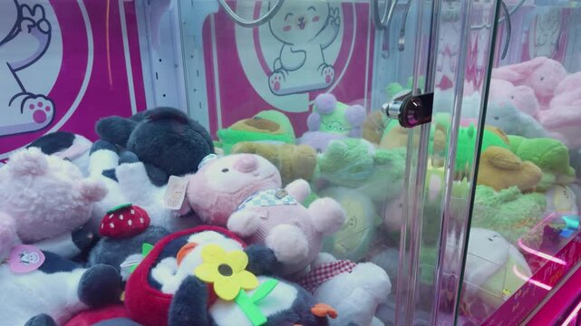Claw machine filled with a colorful variety of soft plush toys and cute stuffed animals, representing entertainment, childhood fun, and games at an arcade in da nang