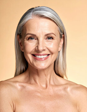 Mature woman portrait with gray hair, smiling face, and natural beauty against warm background