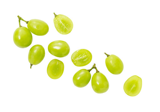 Grains of shine muscat grapes and cut shine muscat grapes on a white background.