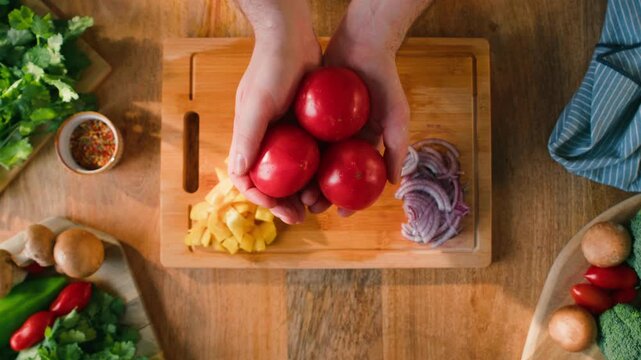 Chop tomato close up, Diced kumato tomatoes on a cutting board for Italian sauce, chef cut tomatoes with knife for gazpacho or salad 
