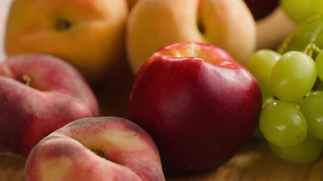Fruit table with grapes, nectarines, peaches and apricots, fresh diet snack close-up