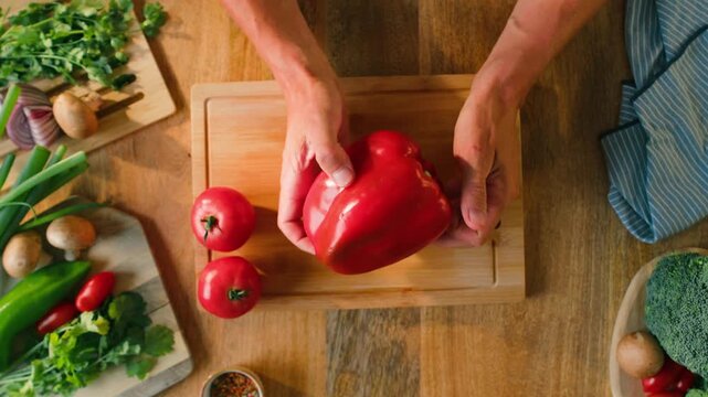 Man cut red sweet pepper, Chef hands with knife for onion, cutting and preparation with cooking for dish. Restaurant, culinary service and cook with skills for catering, business and hospitality by