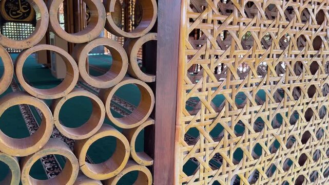 Intricate bamboo craftsmanship forming a decorative wall inside a mosque in South Kalimantan