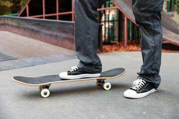 Man riding skateboard in skate park, closeup © New Africa