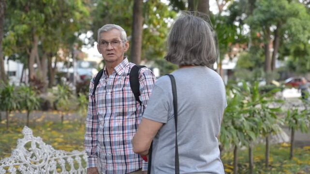 Senior Couple Talking While Standing in a Public Park